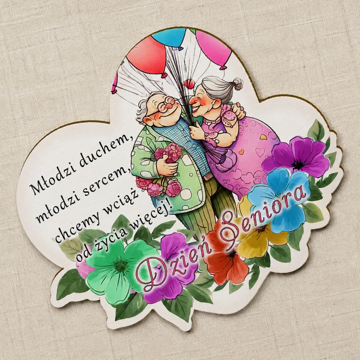 Prezent dla seniorów z ilustracją pary, balonami, kwiatami i pogodnym hasłem na Dzień Seniora
