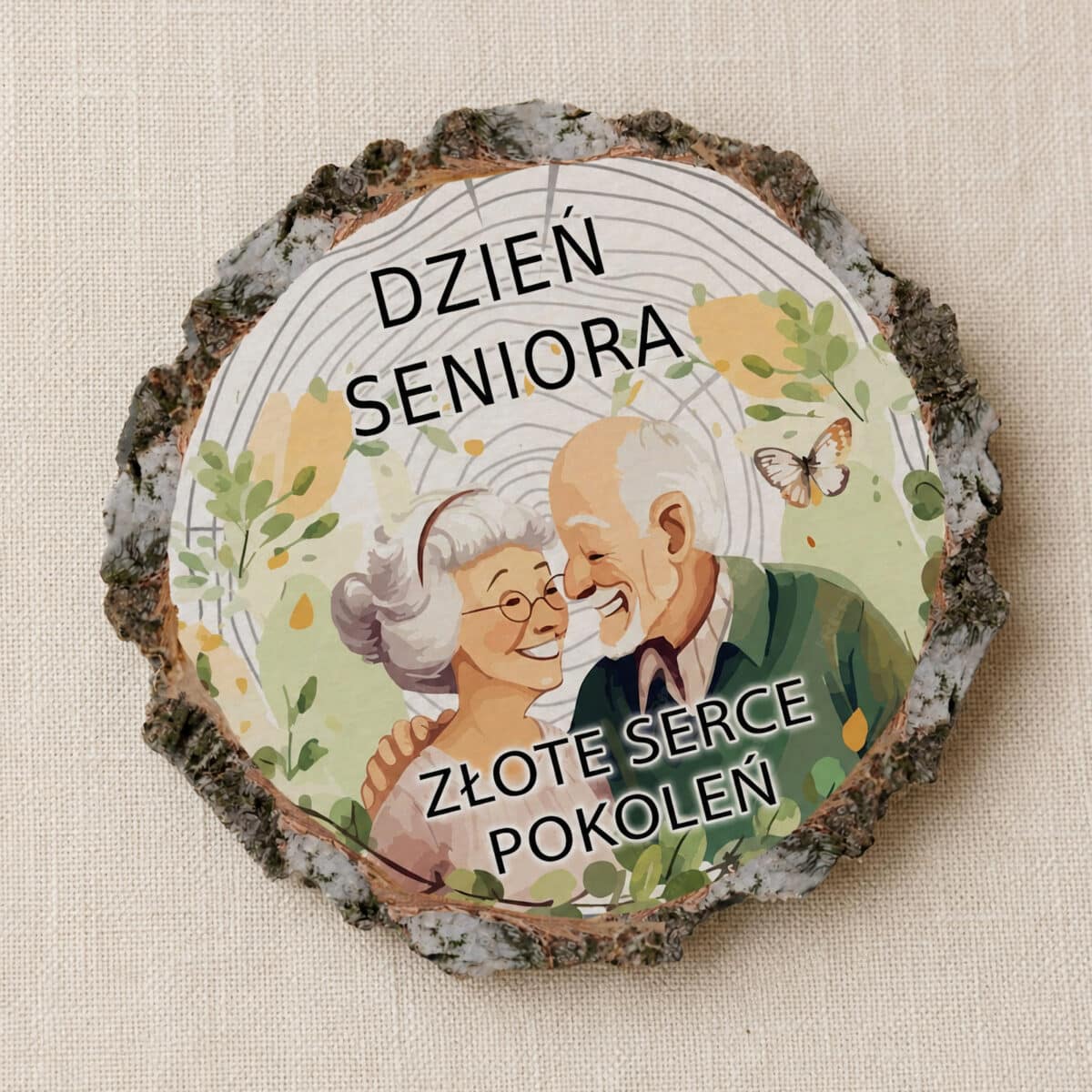 Magnes na Dzień Seniora z parą seniorów, motywami roślinnymi i napisem Złote serce pokoleń